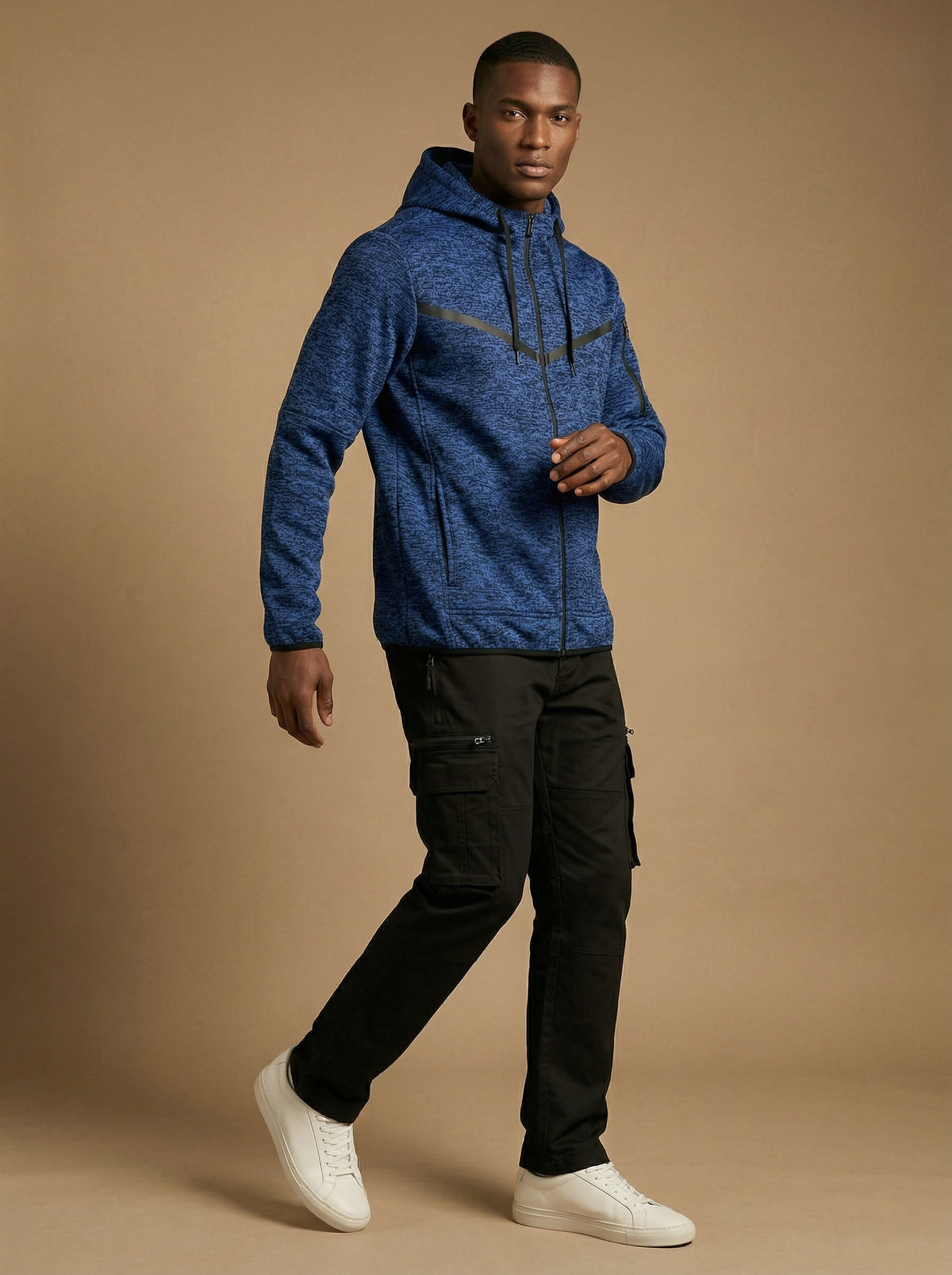 Man wearing the cationic royal blue tech fleece hoodie