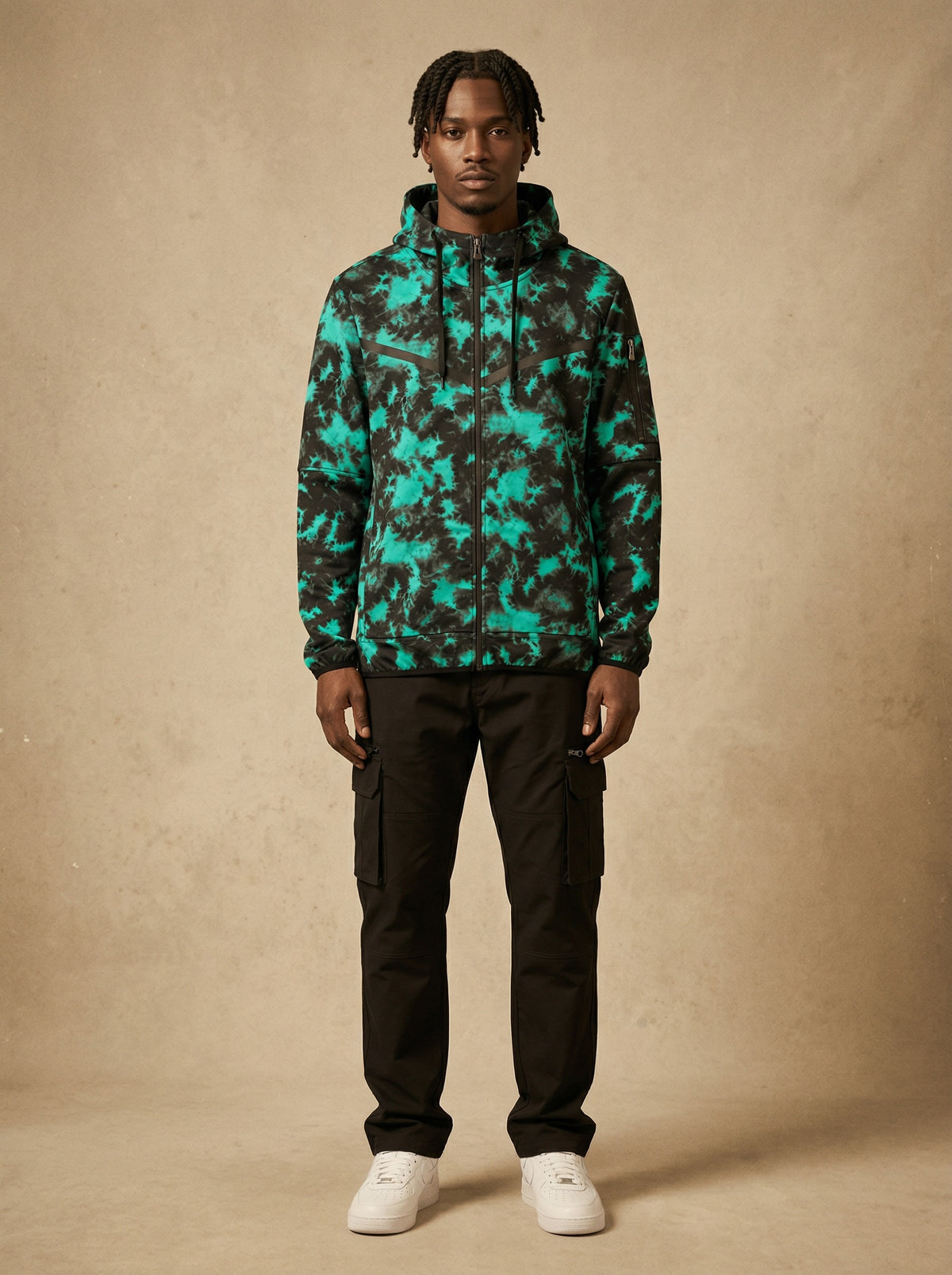 Man wearing the green print tech fleece zip-up hoodie